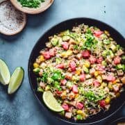 Tuna Ceviche served in a black bowl and photographed from overhead.