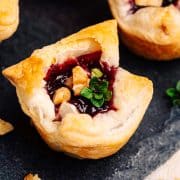 Close up photo of Brie Puff Pastry Bites on a slate serving platter.