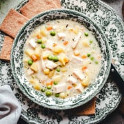 Chicken Pot Pie Soup in green and white bowls photographed from the top.