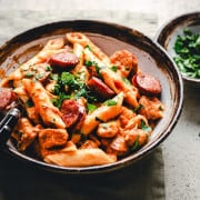 Chicken and Sausage Pasta in a ceramic bowl photographed at an angle.