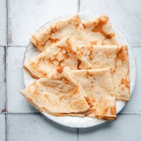 Breakfast Crepes served on a white ceramic plate.