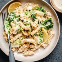 Caesar Pasta Salad served in a cream ceramic bowl.