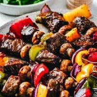 Steak Kabobs that were cooked in the Oven served on a gray ceramic plate.