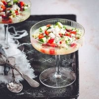 Scallop Ceviche served in coupe glasses on a metal tray.