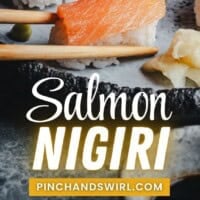 Close-up of salmon nigiri on a dark plate, garnished with wasabi. Chopsticks hold a piece, while hands shape rice in a smaller image below. Text reads "Salmon Nigiri" and "pinchandswirl.com".