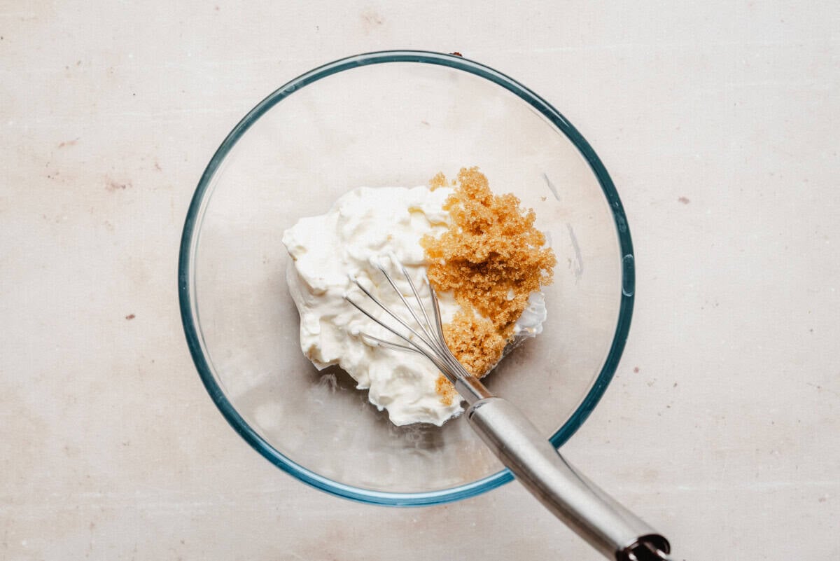 sour cream with brown sugar in a glass bowl, ready to mix.