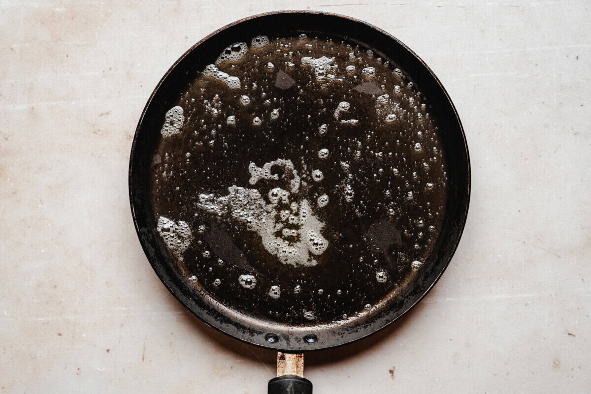 Crepe pan with sizzling melted butter,.