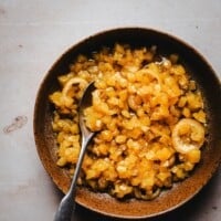A bowl of chunky pineapple marmalade with lemon slices, shown with a spoon, on a light surface. Text above reads "Pinch and Swirl Pineapple Marmalade" and the website "pinchandswirl.com" appears below.